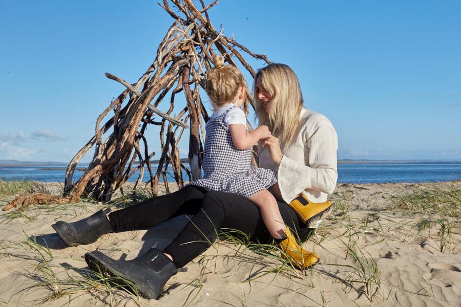 mother and daughter playing on a beach